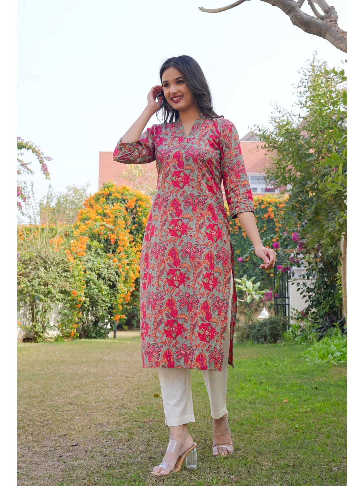 Aromie single piece kurta worn by smiling model outdoors in pink floral print with beige pants Embroidered jumpsuit for women