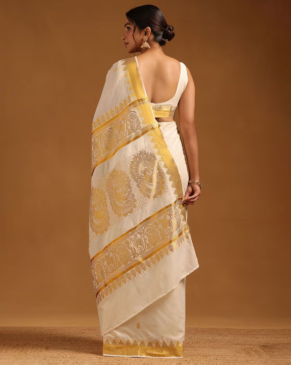 Elegant white Banarasi Silk Saree with golden zari work, perfect for weddings and festive occasions.