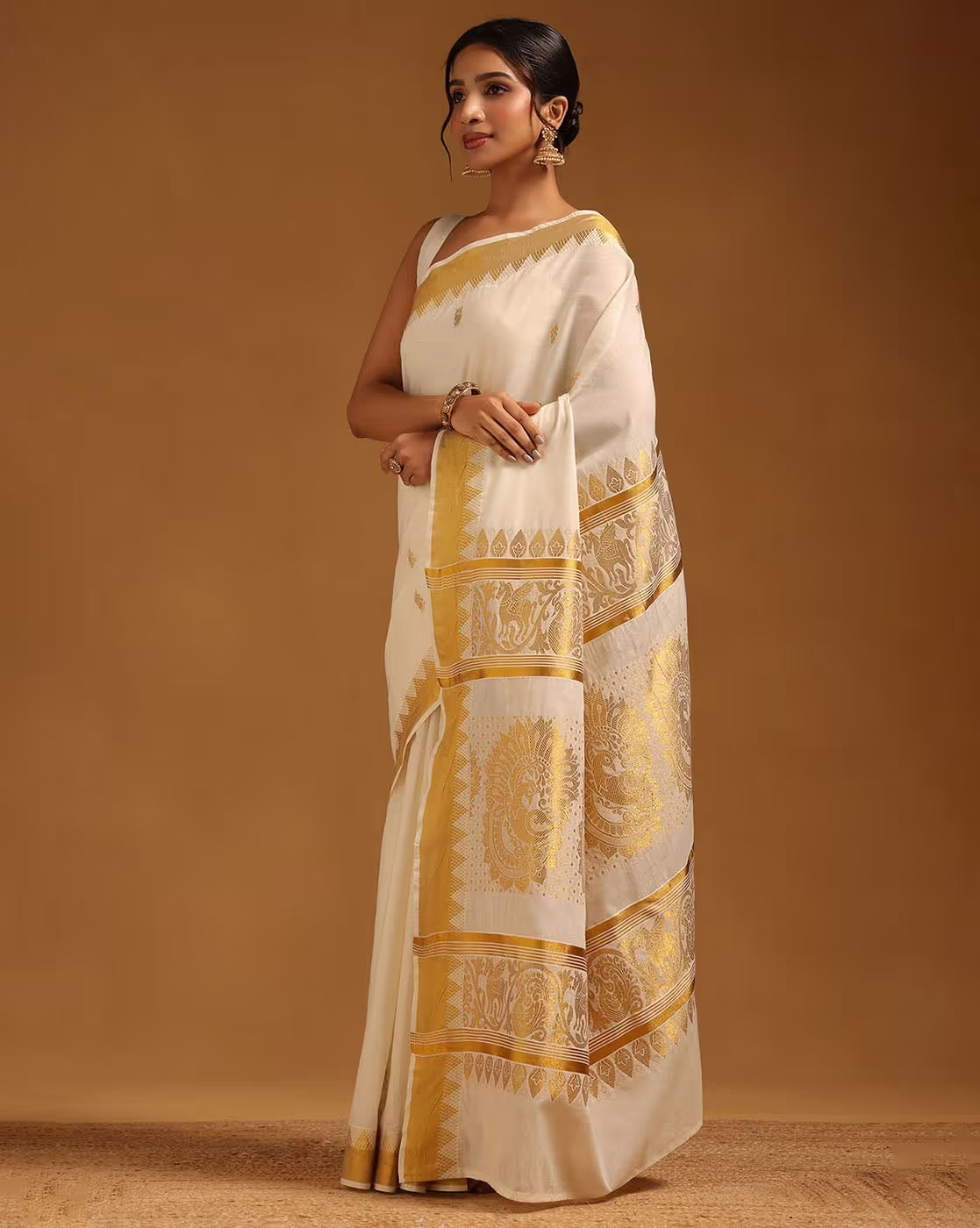 Elegant cream Banarasi Silk Saree Online with gold detailing, perfect for weddings and festive occasions.