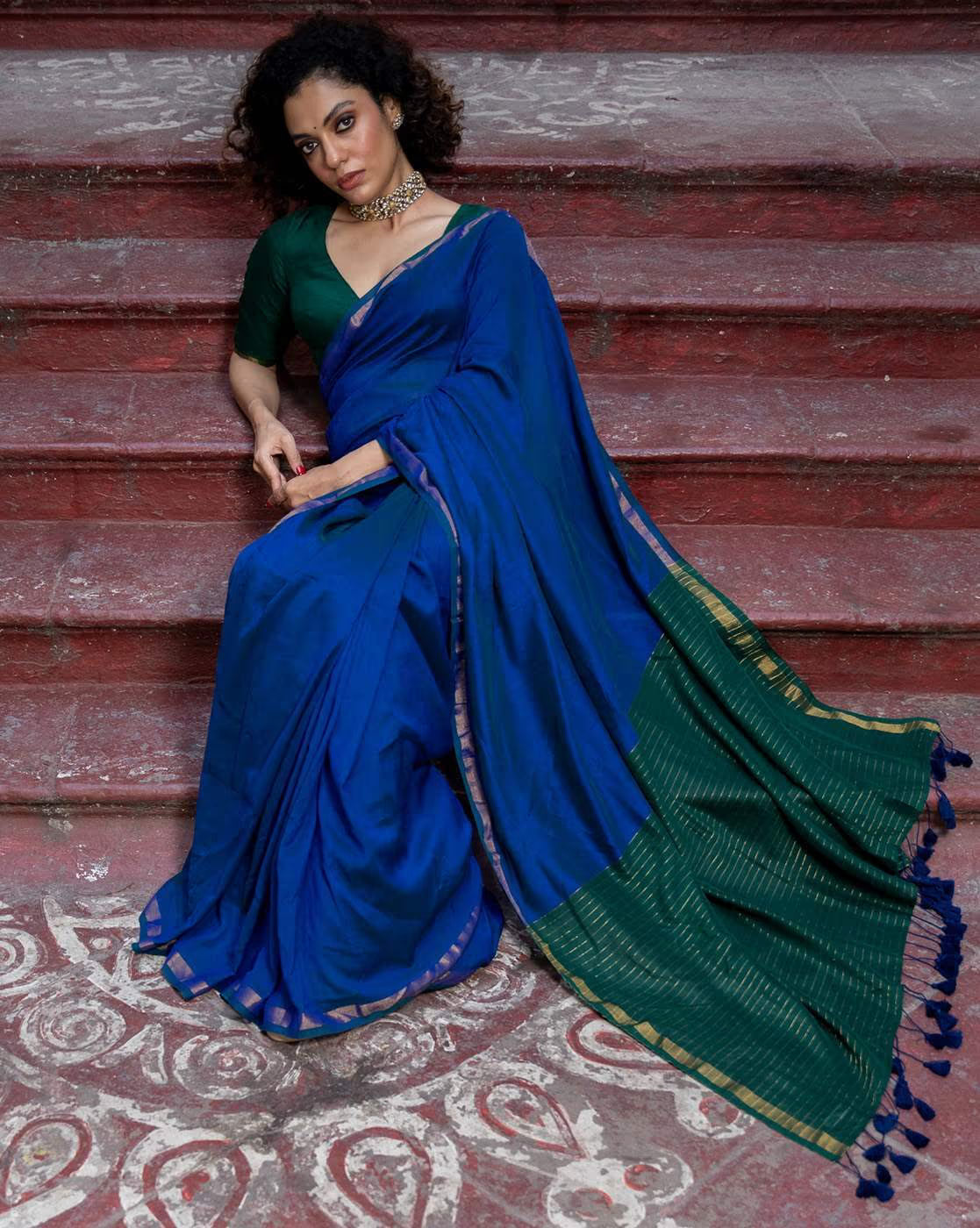 Elegant Bandhani Silk Saree Online in Blue and Green, styled with a matching blouse on traditional steps