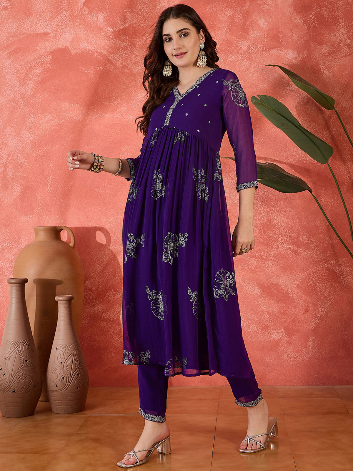 Floral Anarkali Kurta Set in purple with embroidery, paired with matching pants and stylish accessories