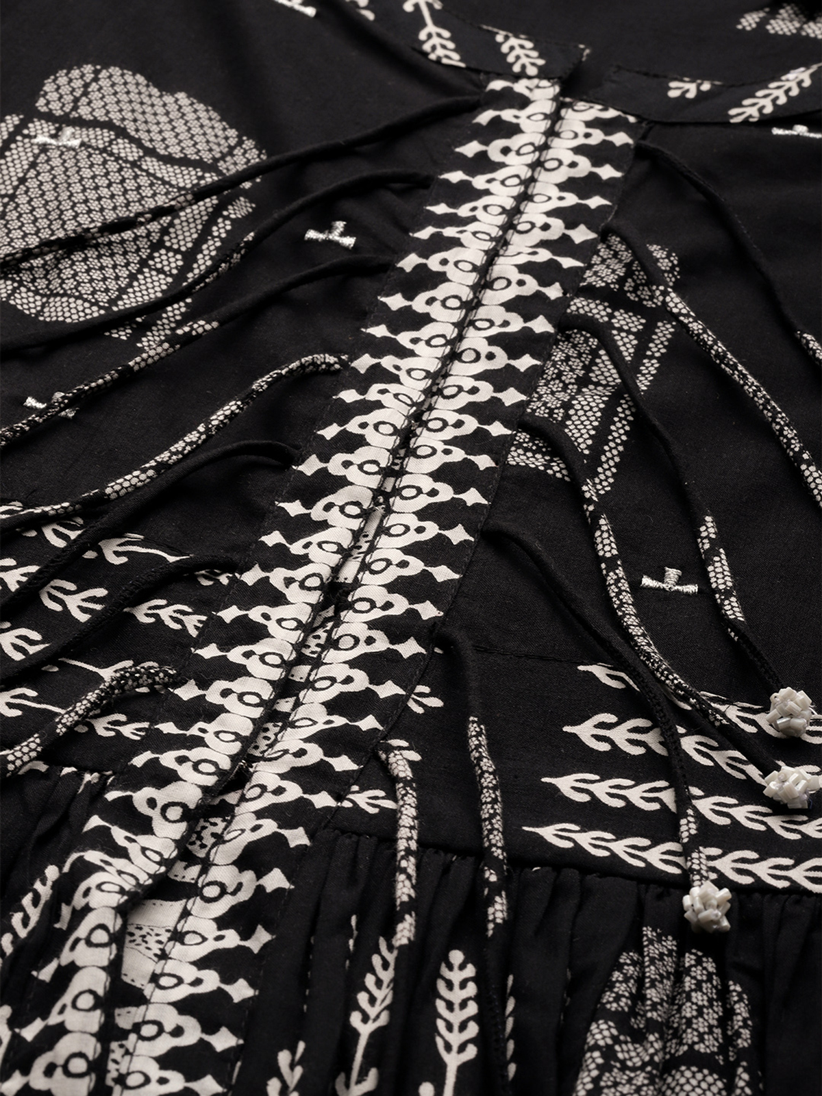 Close-up view of black floral cotton kurta set featuring intricate patterns and elegant design details