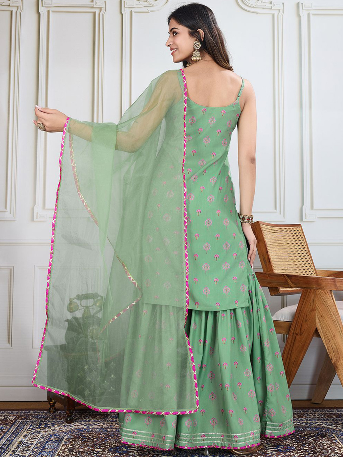 Elegant black printed kurta set with a flowing green design and decorative dupatta for stylish occasions