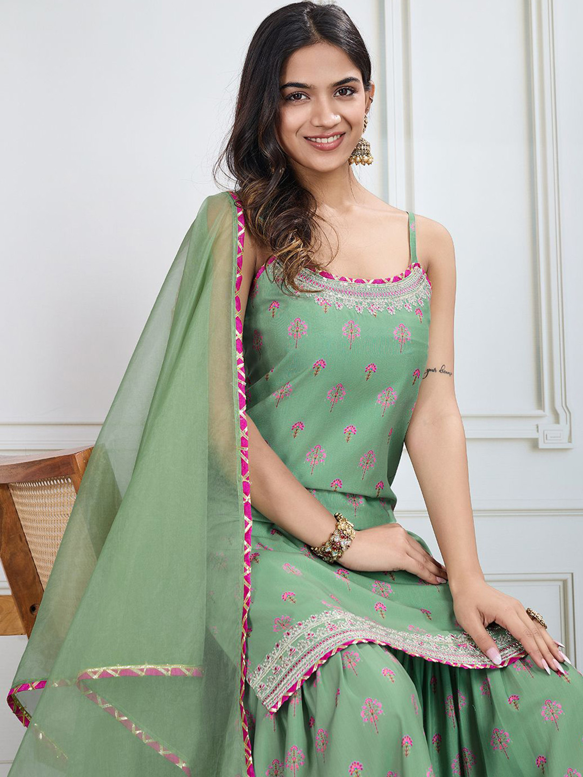 Elegant green three piece Kurtha set featuring intricate prints and a matching dupatta for stylish wear