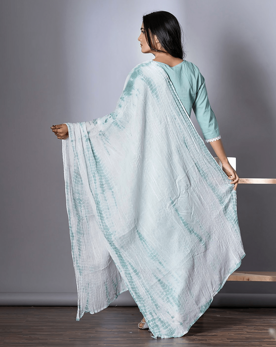 Back view of a three piece blue cotton kurti set with elegant drape and stylish design