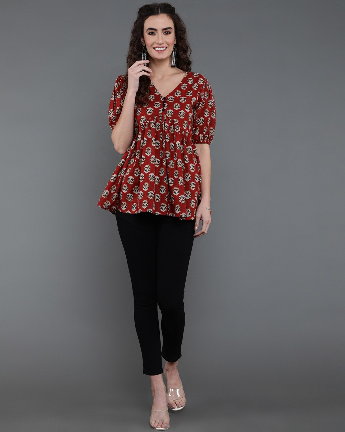 Aromie model wearing red floral peplum V neck Rayon casual top women with puff sleeves and black pants