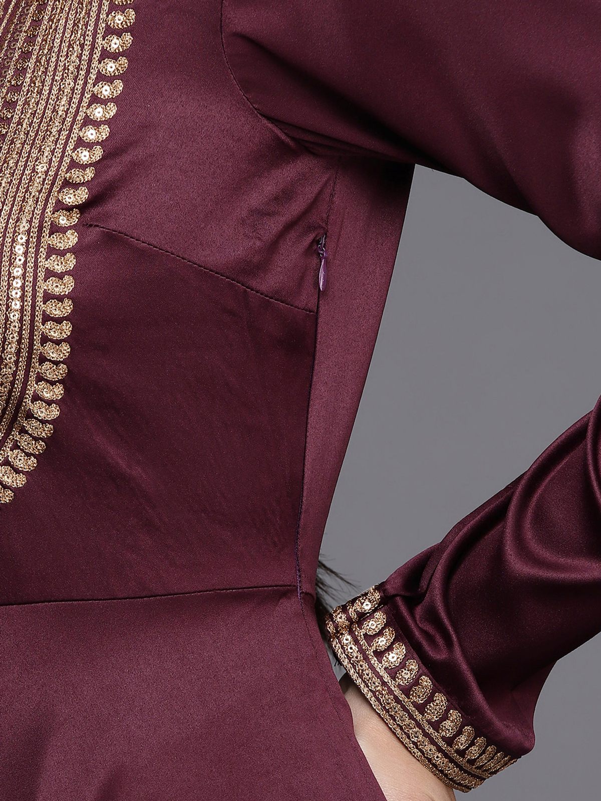 Close-up of the burgundy satin anarkali kurta featuring intricate embroidery and a side zipper detail