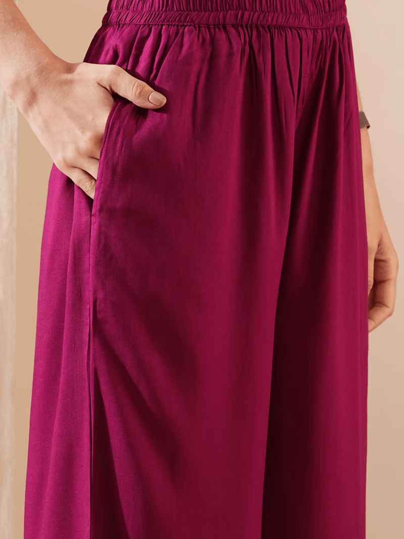 Elegant bandhani kurta set with stylish pants and pockets in a rich magenta color