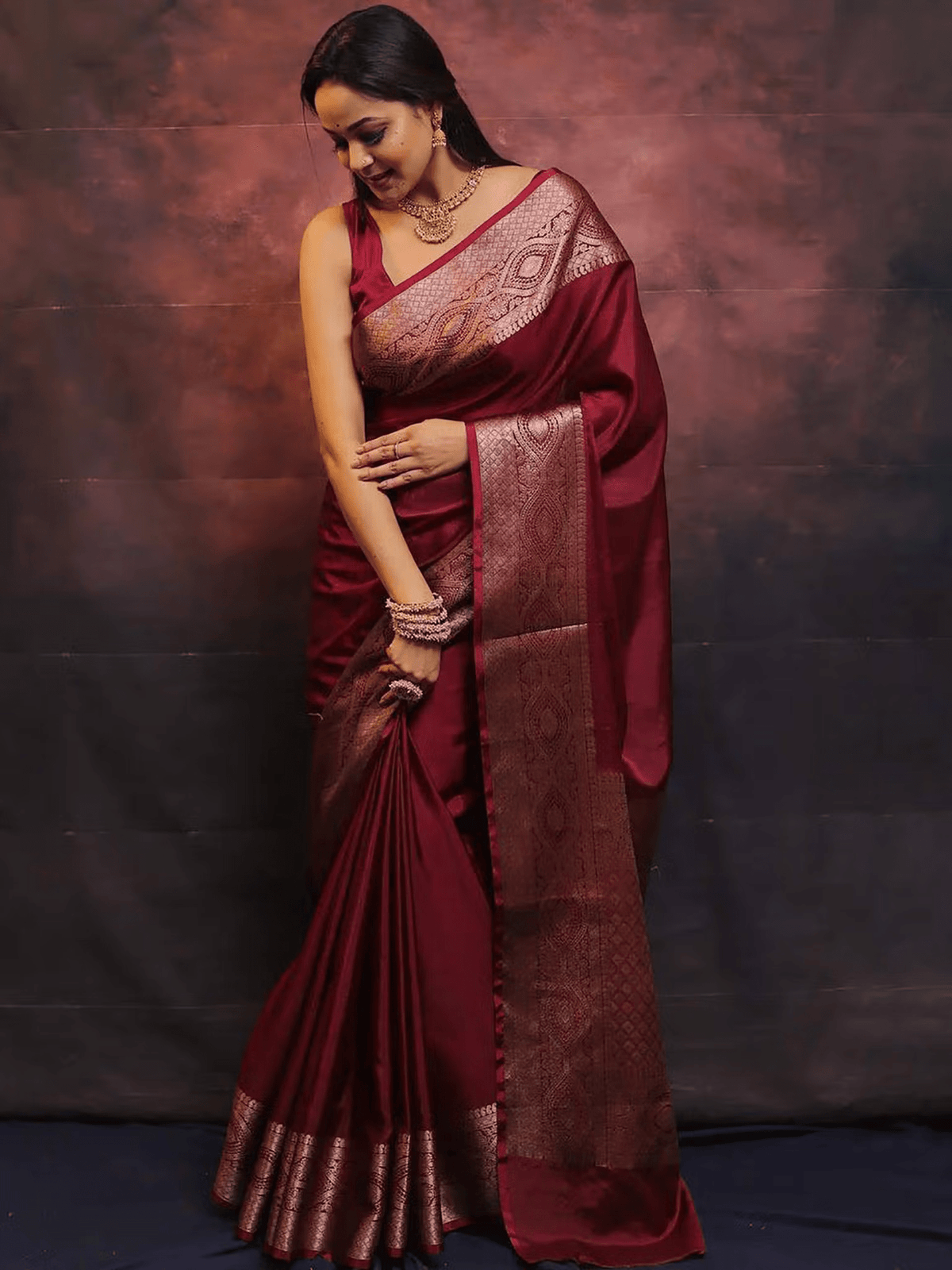 Aromie elegant festive saree set in deep maroon with intricate gold border and traditional patterns