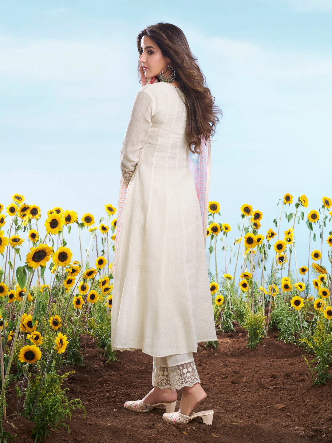 Elegant three piece kurta set in off-white fabric, perfect for weddings, showing back view with sunflowers