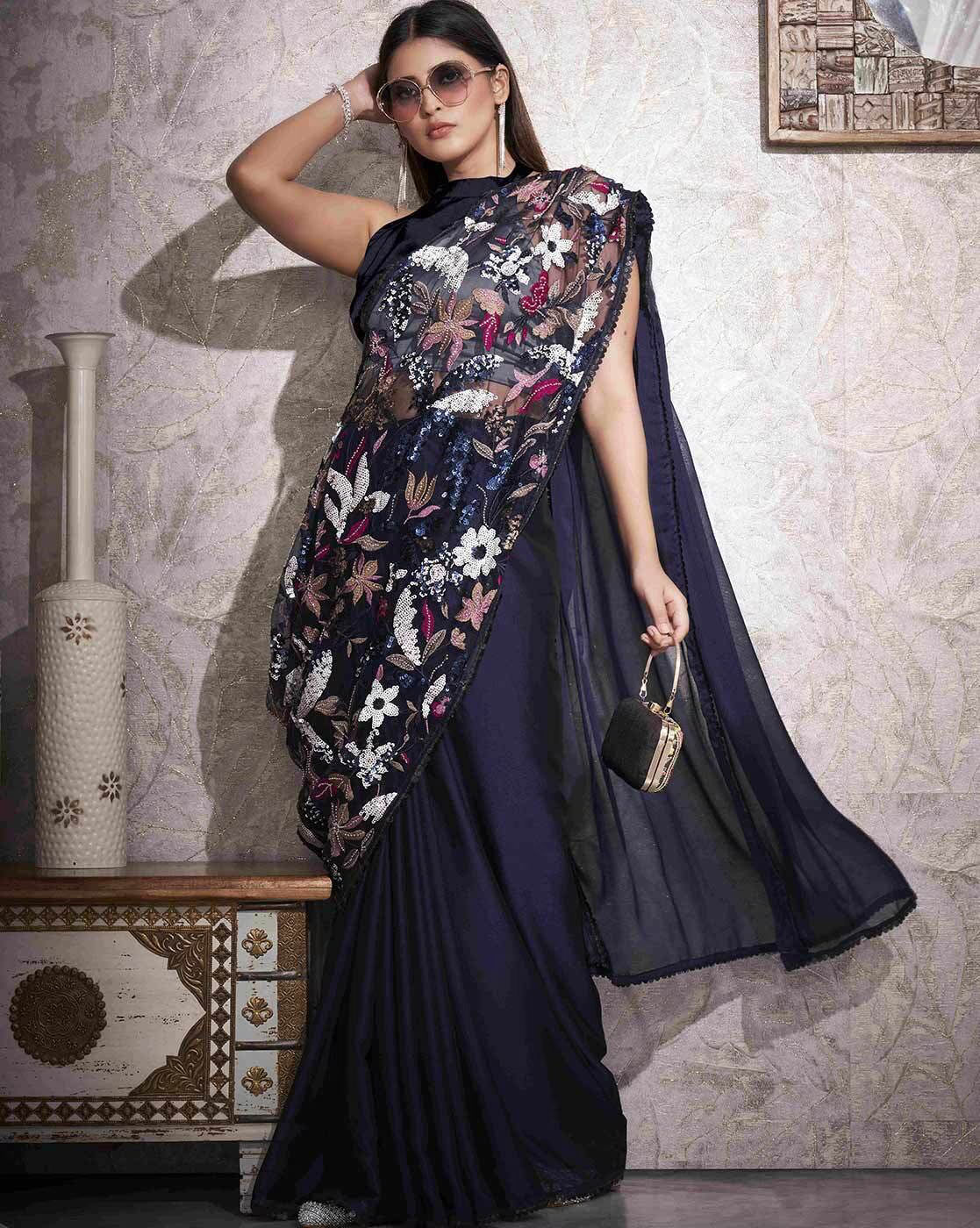 Elegant navy embellished saree with stones featuring intricate floral designs and a stylish drape