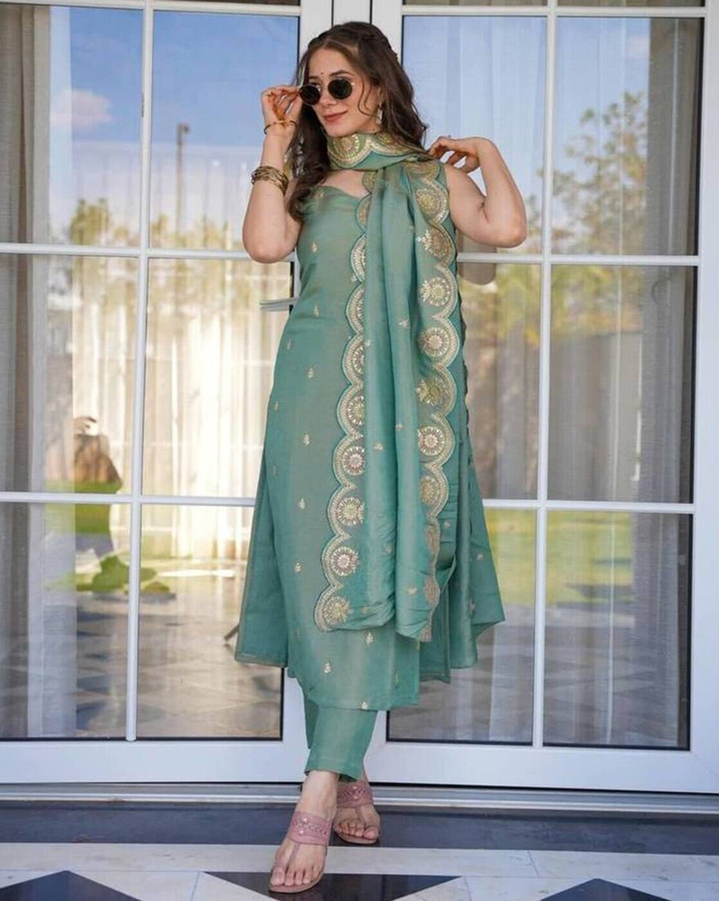 Aromie embroidered Anarkali kurta set in green with matching dupatta and pants worn by a woman