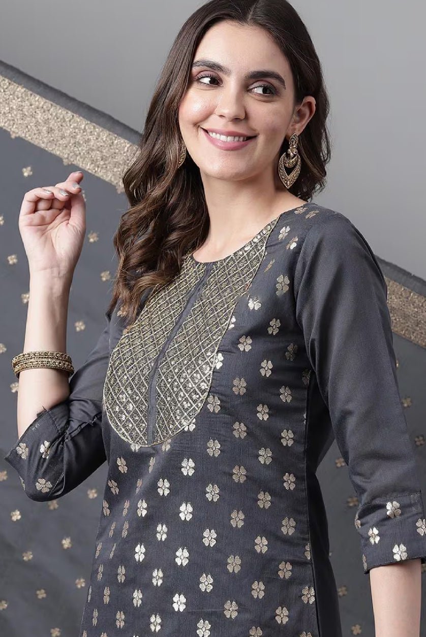 Elegant woman wearing an Embroidered Chanderi Kurta Set with intricate gold detailing and a stylish neckline