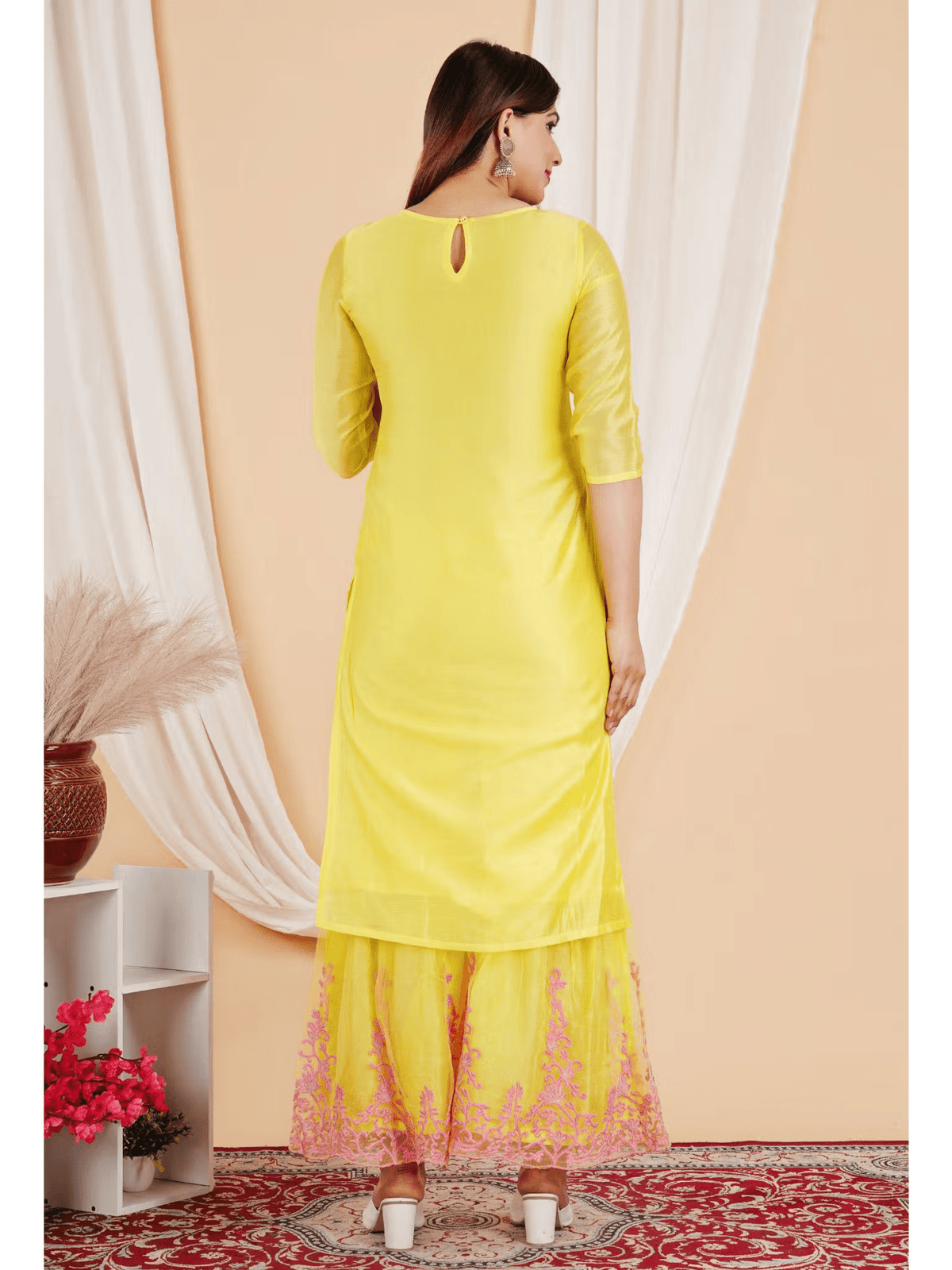 Back view of a yellow embroidered Chanderi kurta set featuring intricate lace detailing.