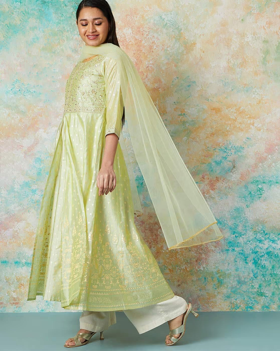 Embroidered flared kurta set in light green with matching salwar and dupatta for elegant festive wear