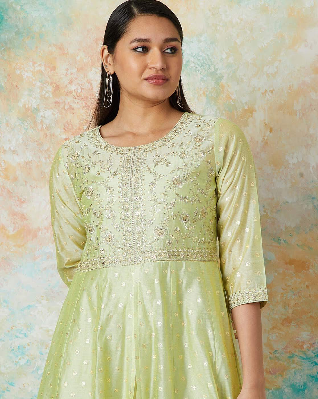 Embroidered flared kurta set in light green with intricate detailing, perfect for festive occasions