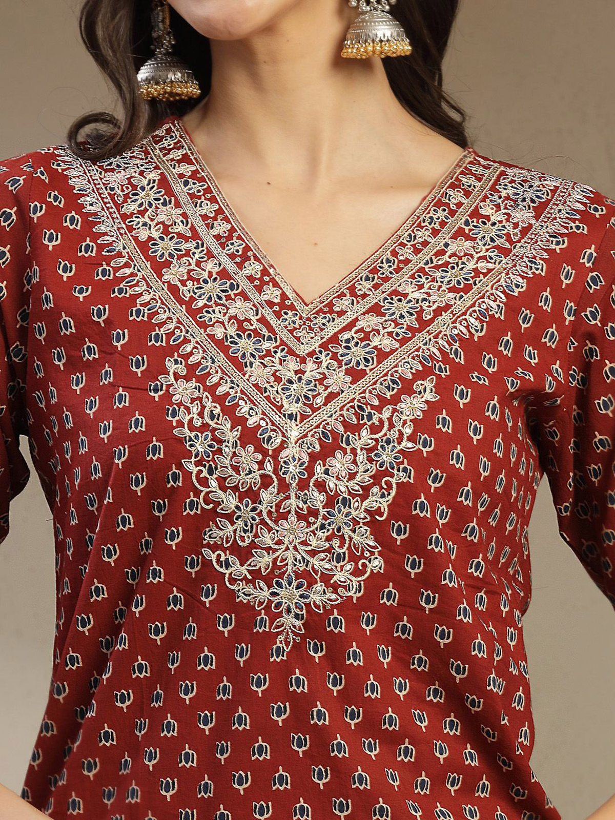 Aromie single piece kurta featuring detailed embroidery on a rust-colored fabric inspired by embroidered georgette jumpsuit style