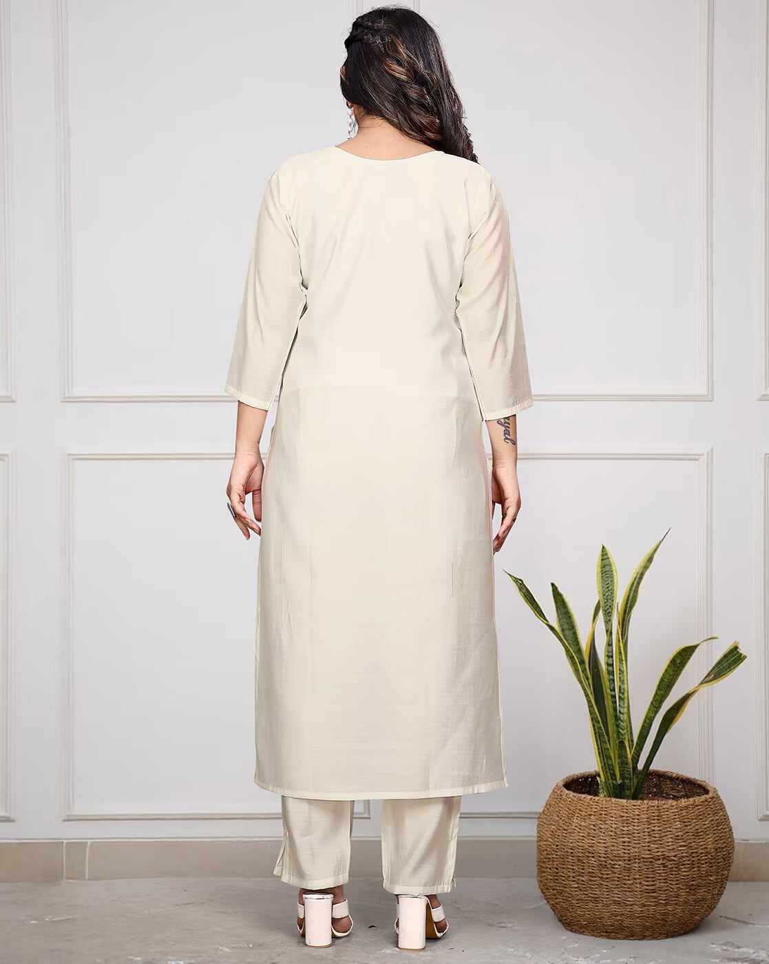 Back view of an embroidered kurta set for women in cream color, featuring three pieces and a relaxed fit