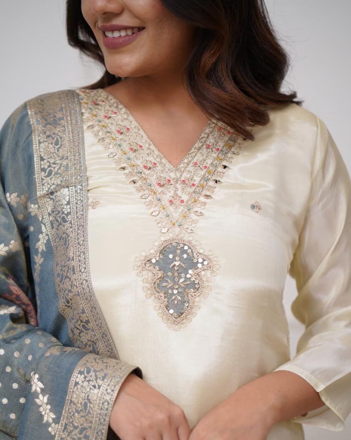 Elegant three piece embroidered kurta set for women in cream and blue with intricate embellishments