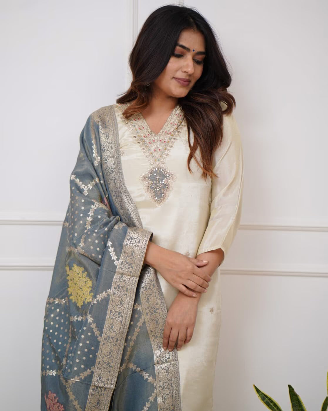 Elegant three piece embroidered kurta set for women featuring intricate designs and a stylish shawl