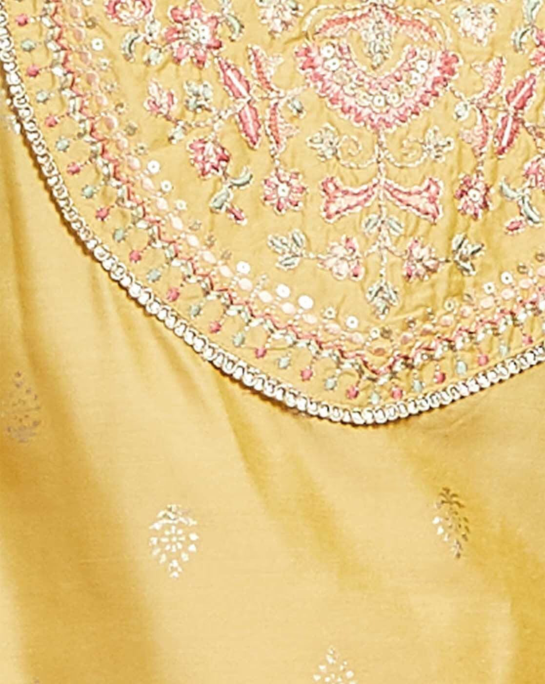 Embroidered kurta suit set for women featuring intricate floral designs on a golden fabric