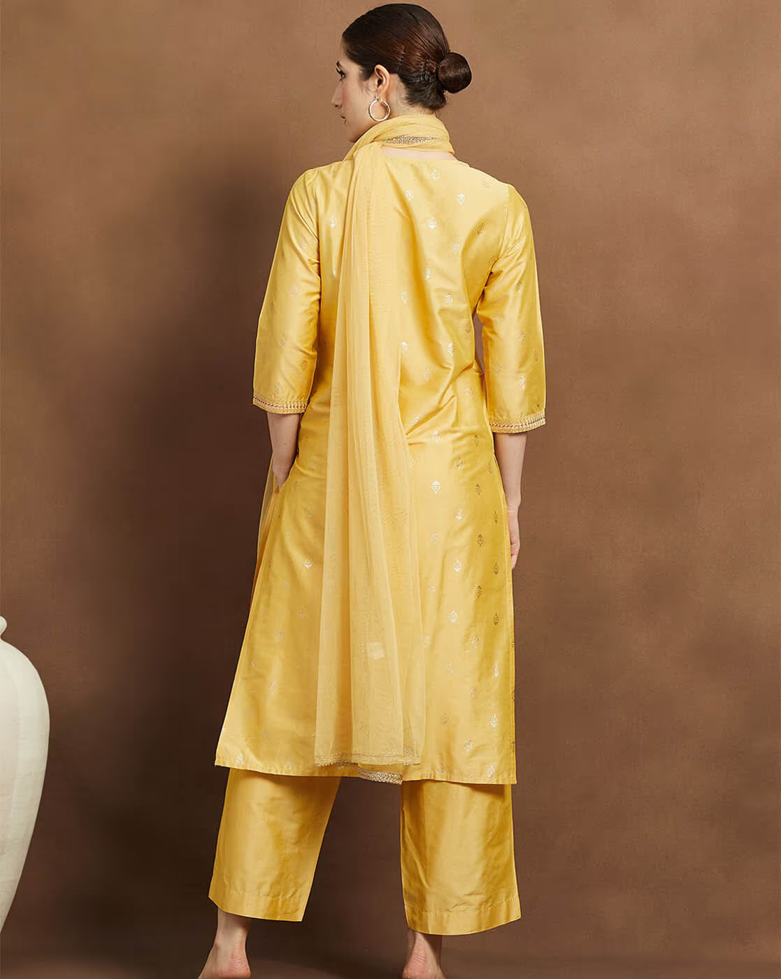 Elegant yellow embroidered kurta suit set for women featuring a back view with matching palazzo and dupatta