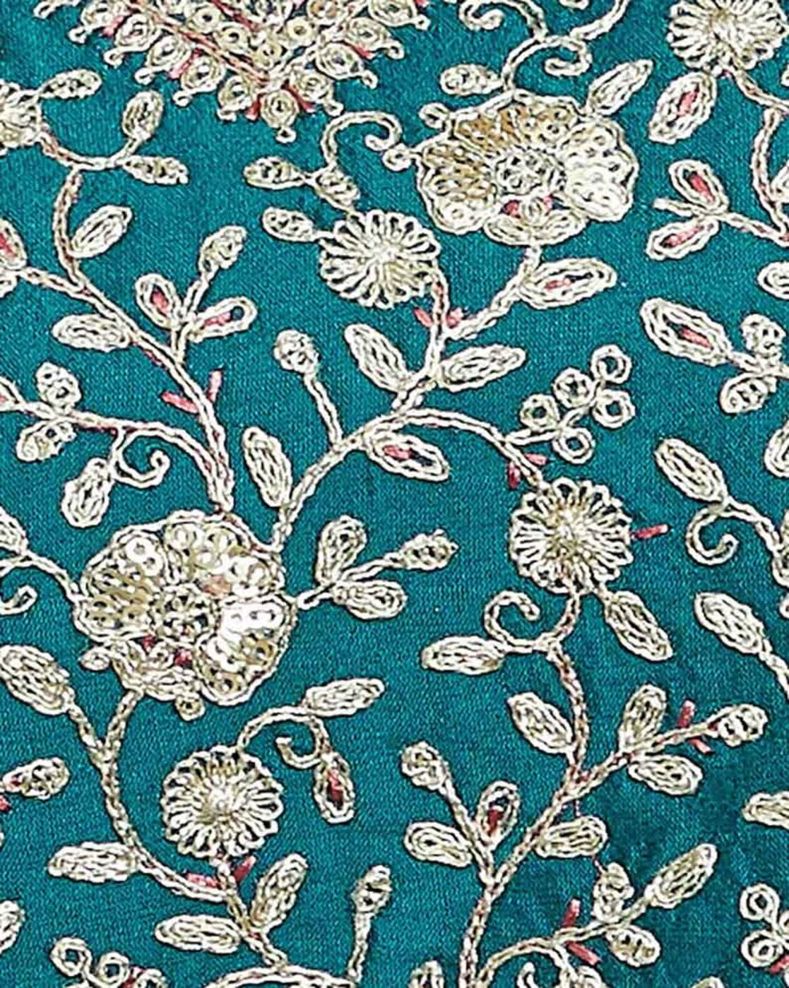 Embroidered kurta suit set for women with intricate floral gold embroidery on a teal background