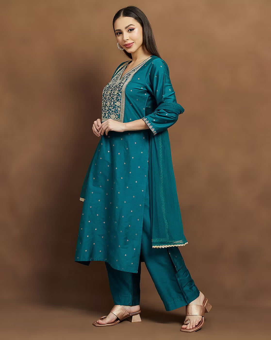 Embroidered kurta suit set for women in teal with elegant designs and matching pants
