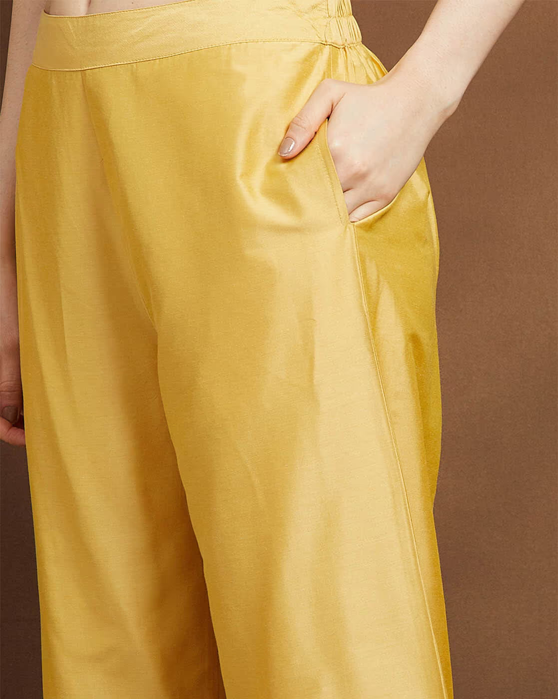 Yellow pants from an embroidered kurta suit set for women with convenient side pockets