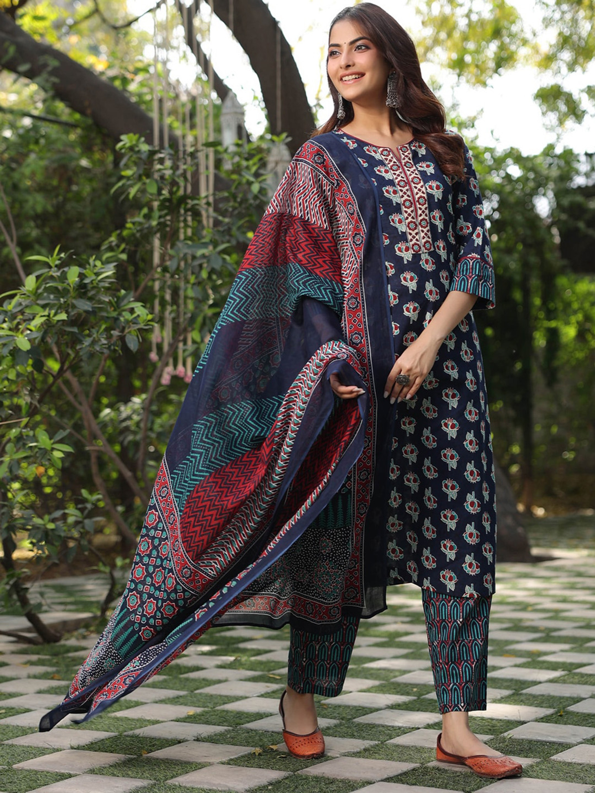 Embroidered Mulmul Kurta Canada featuring a vibrant design, paired with matching trousers and a decorative dupatta.
