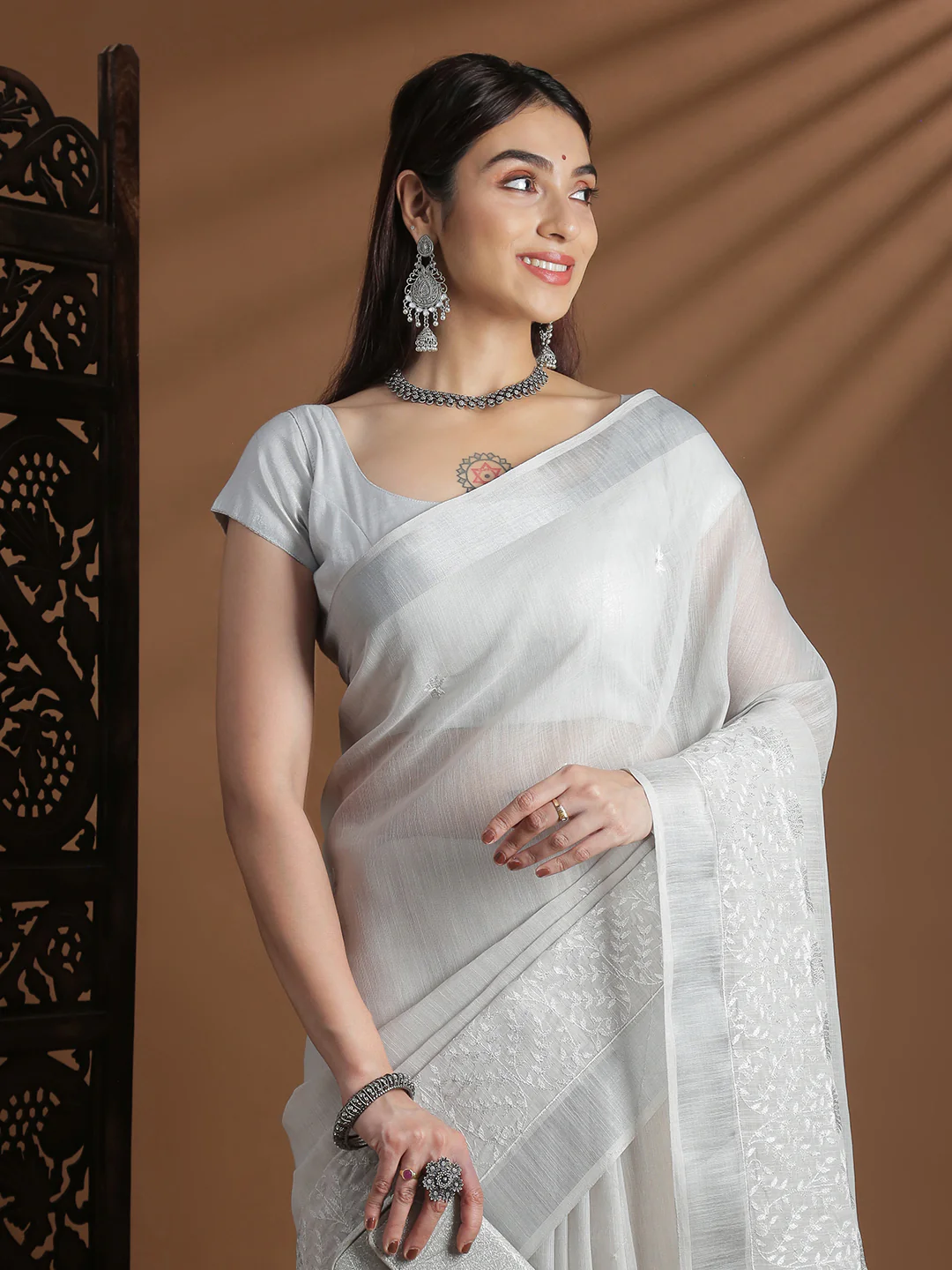 Embroidered Saree in elegant white fabric, featuring detailed work, perfect for weddings or formal events