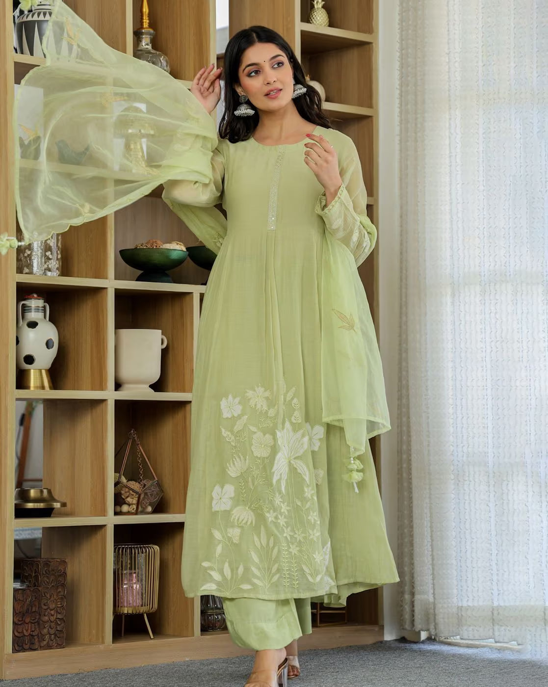 Aromie Embroidery A-line kurta set in soft green with floral designs and flowing sleeves