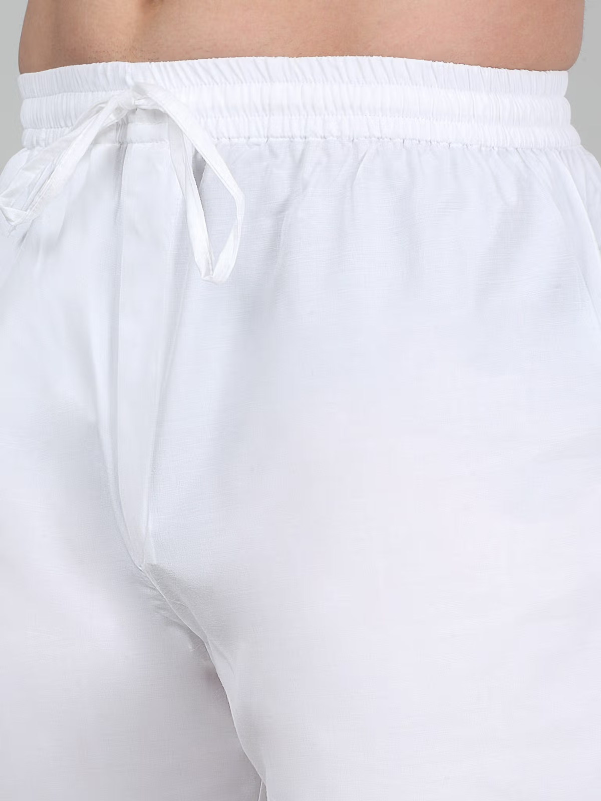 Close up of white drawstring pajama pants from men's burgundy embroidered kurta set by AROMIE