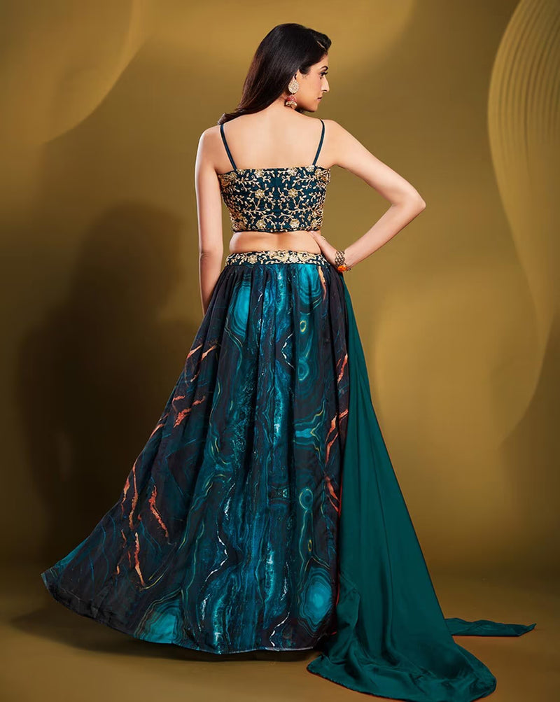 Back view of model in teal embellished lehenga choli set Canada with embroidered strappy choli and flowing skirt