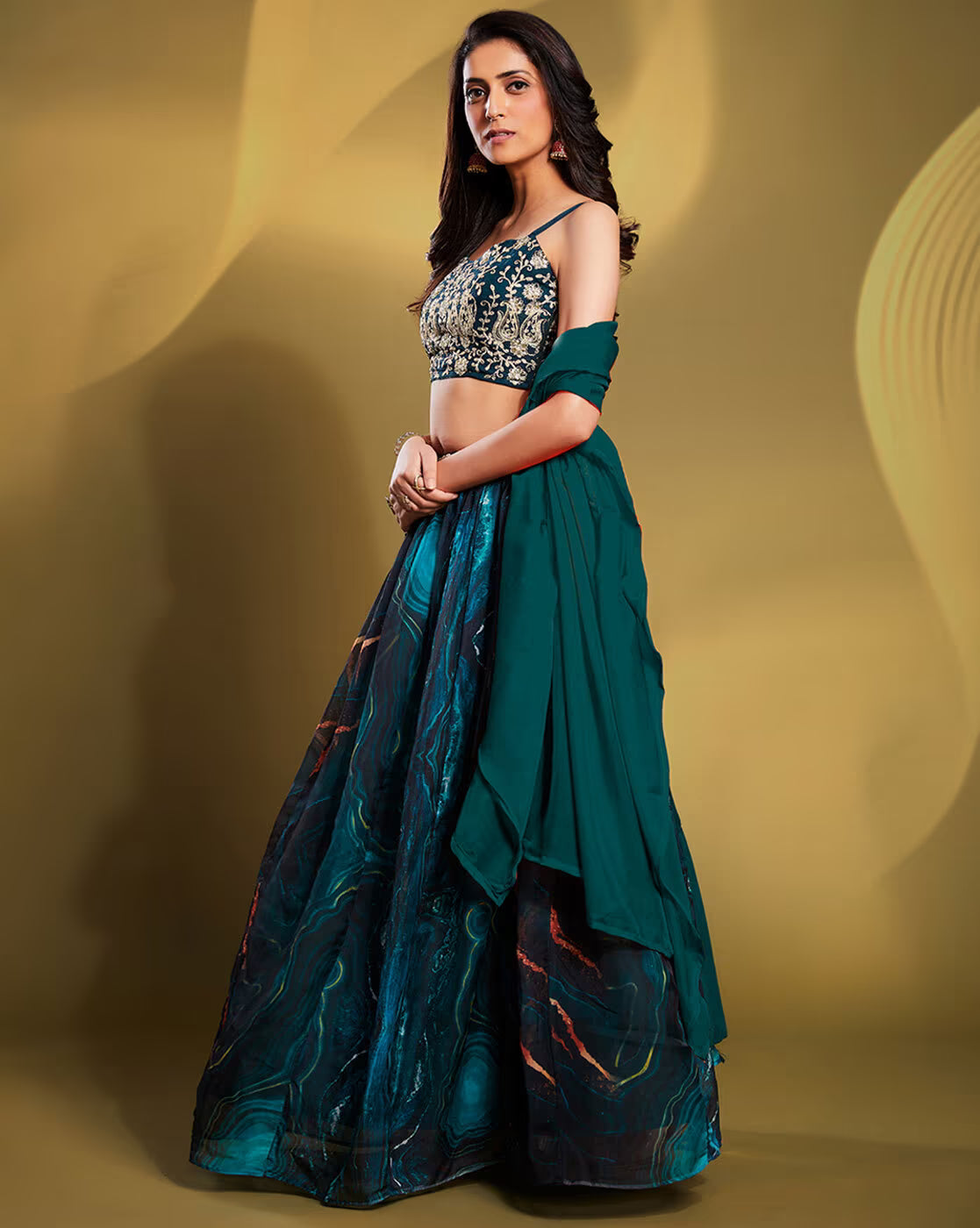 Woman wearing teal embellished lehenga choli set Canada with embroidered crop blouse and flowing dupatta