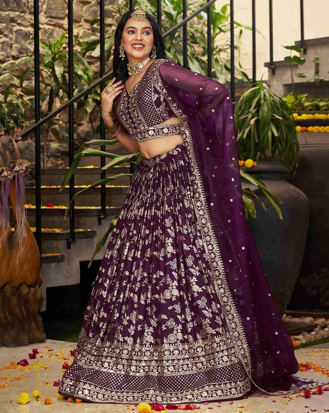 Model wearing deep plum embroidered lehenga choli set Canada with silver floral embroidery and sheer dupatta for wedding
