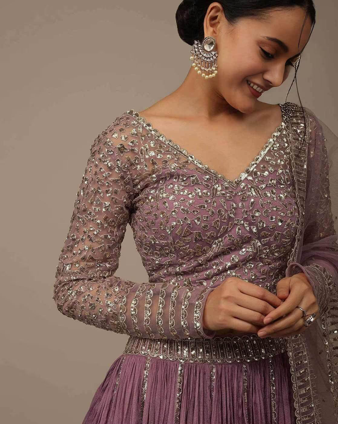 Woman wearing mauve embellished lehenga choli set Canada with mirrorwork embroidery full sleeves and dupatta with jhumka earrings