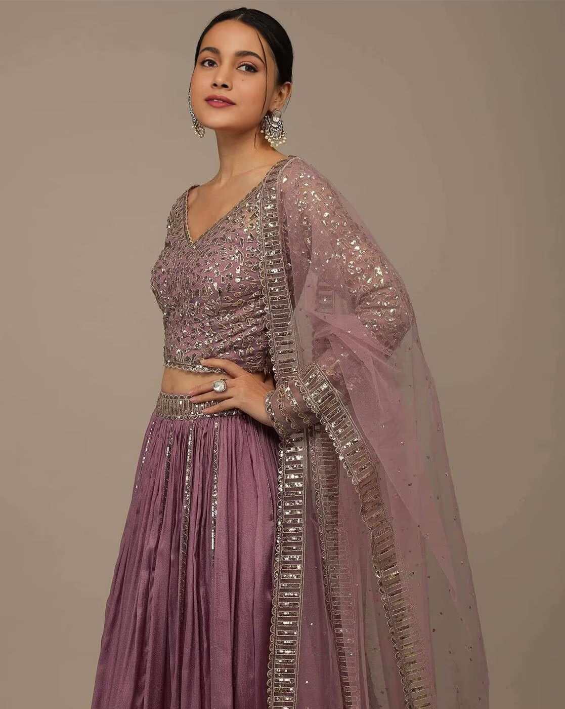 Model wearing mauve sequined embellished lehenga choli set Canada with matching dupatta and jhumka earrings