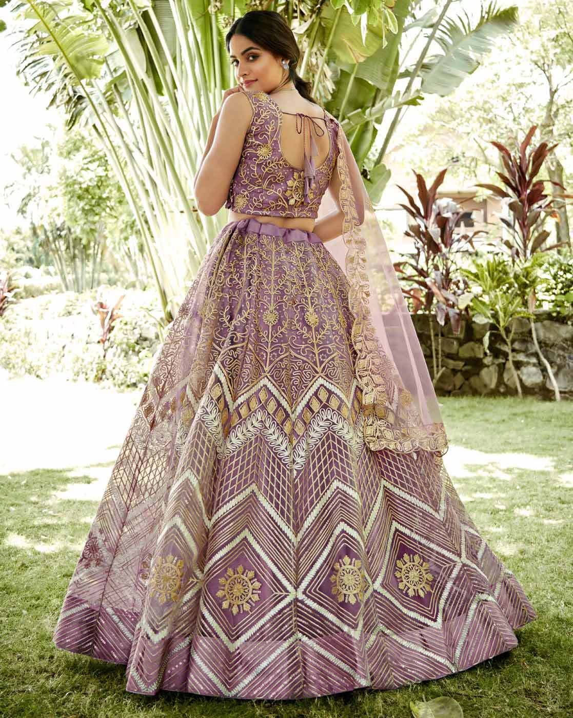 Purple and gold embroidered lehenga choli set Canada with sheer dupatta worn by model in garden