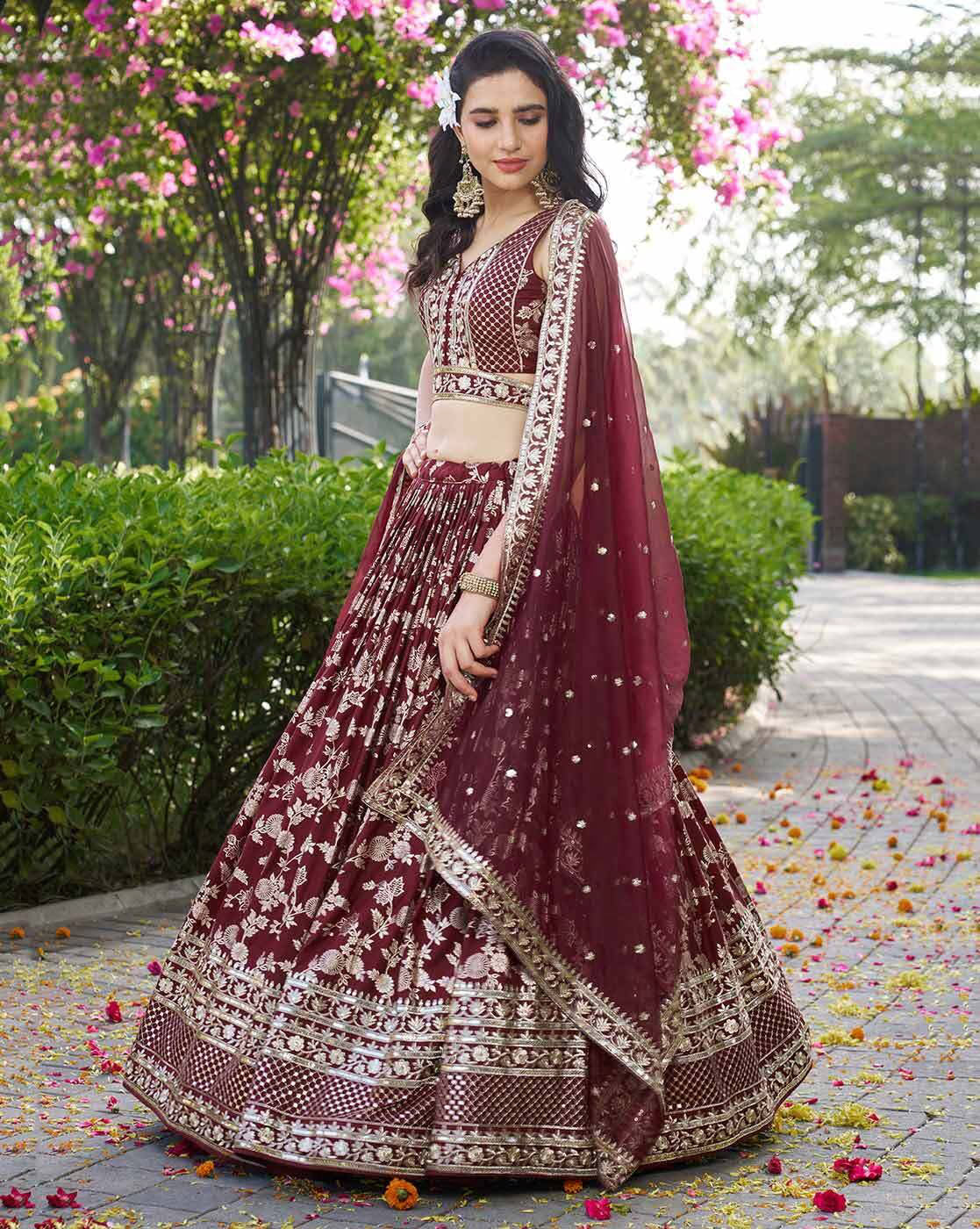 Maroon embroidered lehenga choli set Canada featuring heavy silver embroidery and matching dupatta in garden