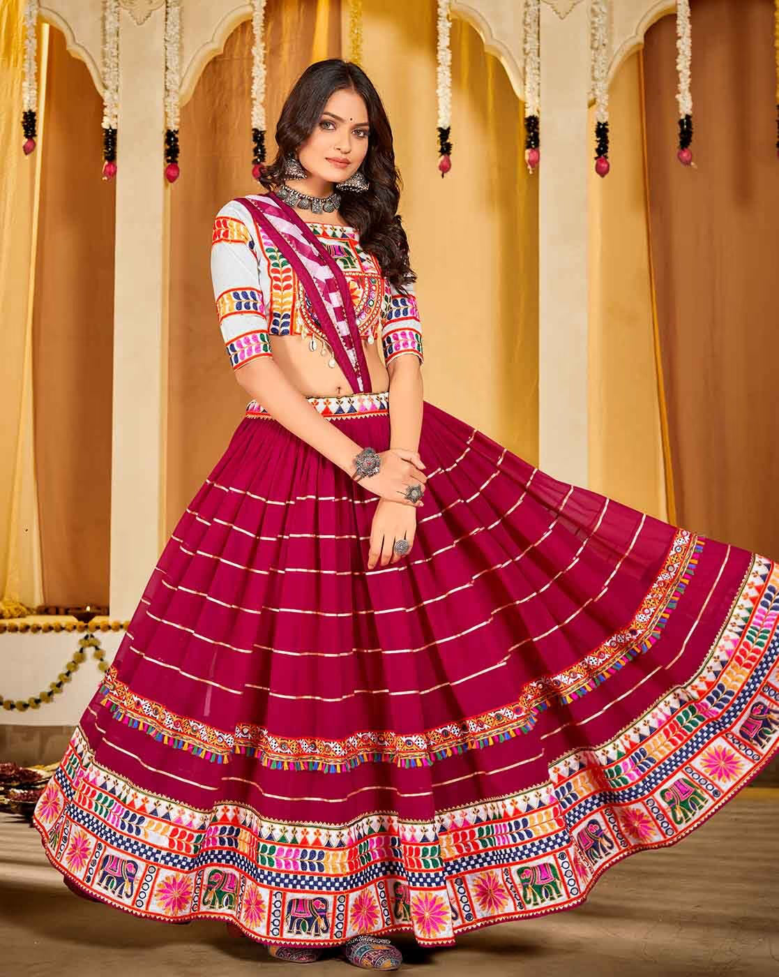 Model wearing magenta embroidered lehenga choli set Canada with colorful embroidered border and matching blouse and dupatta