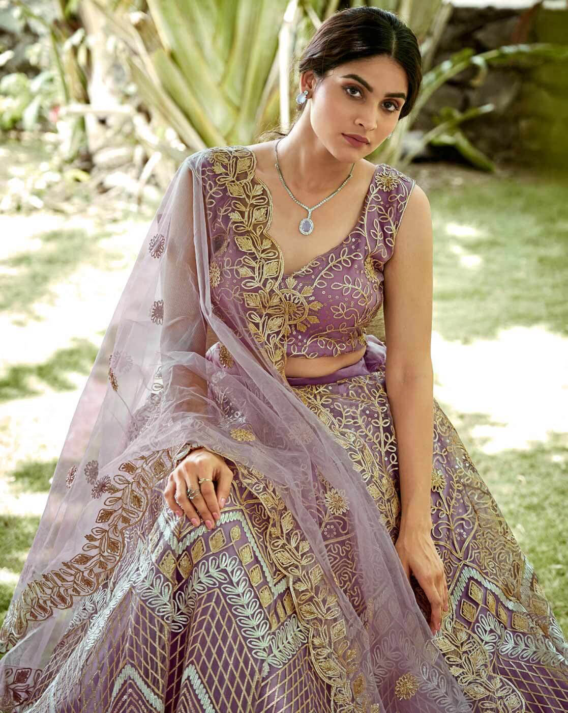 Model wearing an embroidered lehenga choli set Canada in lavender with gold embroidery sheer dupatta and necklace