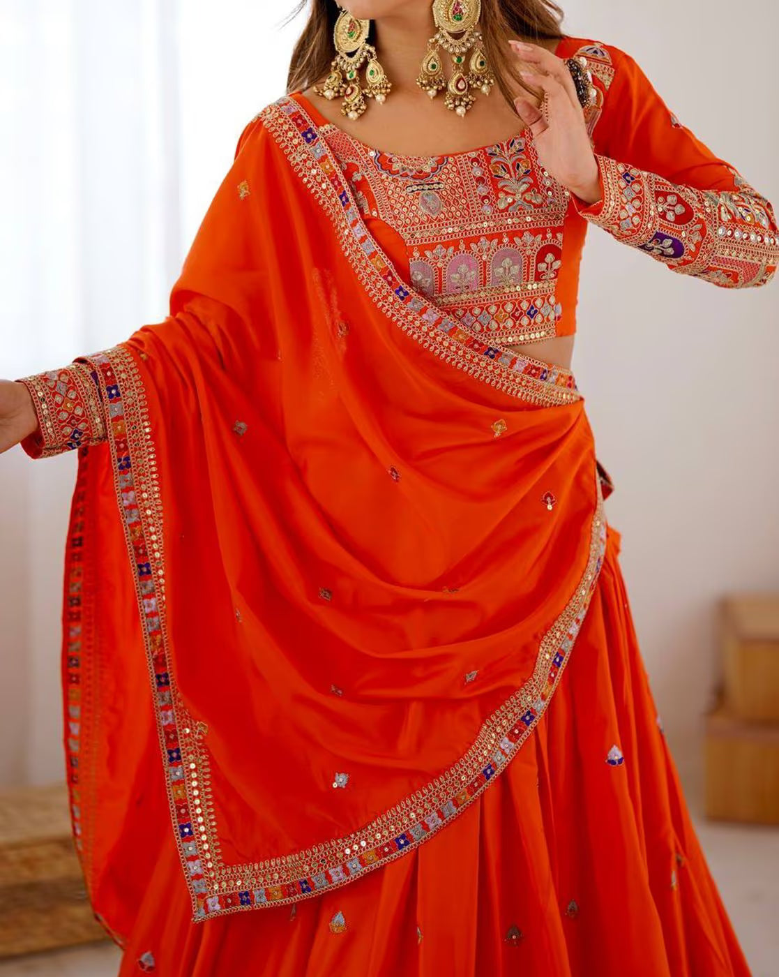 Bright orange embroidered lehenga choli set Canada featuring intricate mirror and thread embroidery on blouse and dupatta