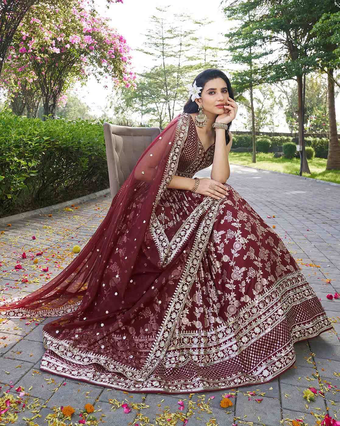 Maroon embroidered lehenga choli set Canada with silver floral embroidery and matching dupatta modeled outdoors