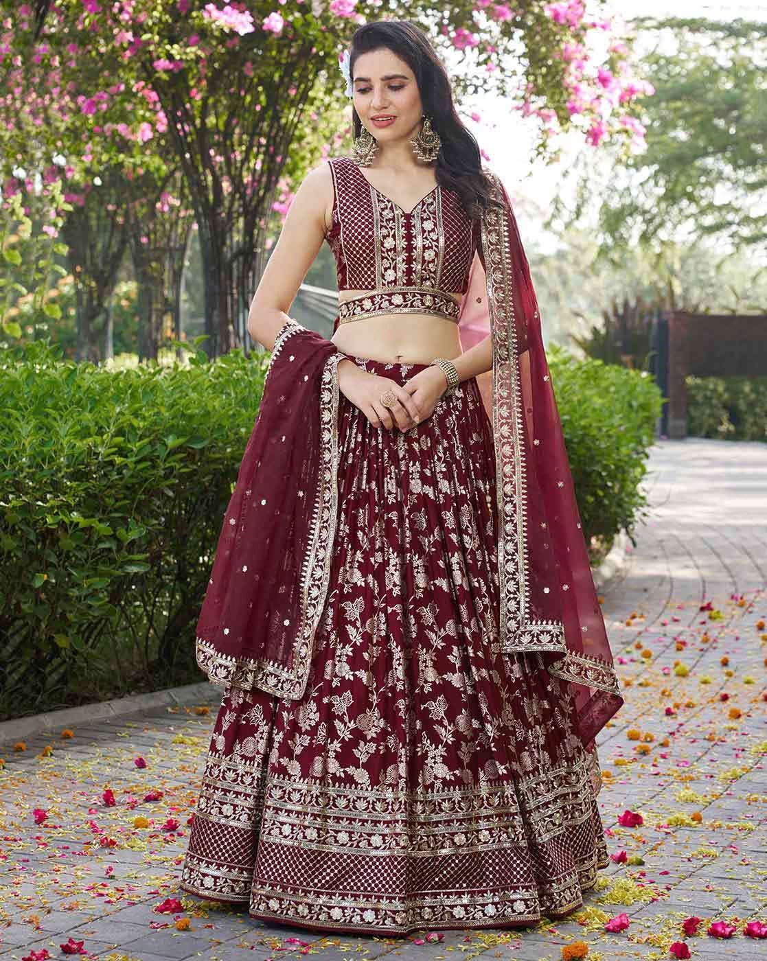 Model wearing maroon embroidered lehenga choli set Canada with intricate gold embroidery and matching dupatta