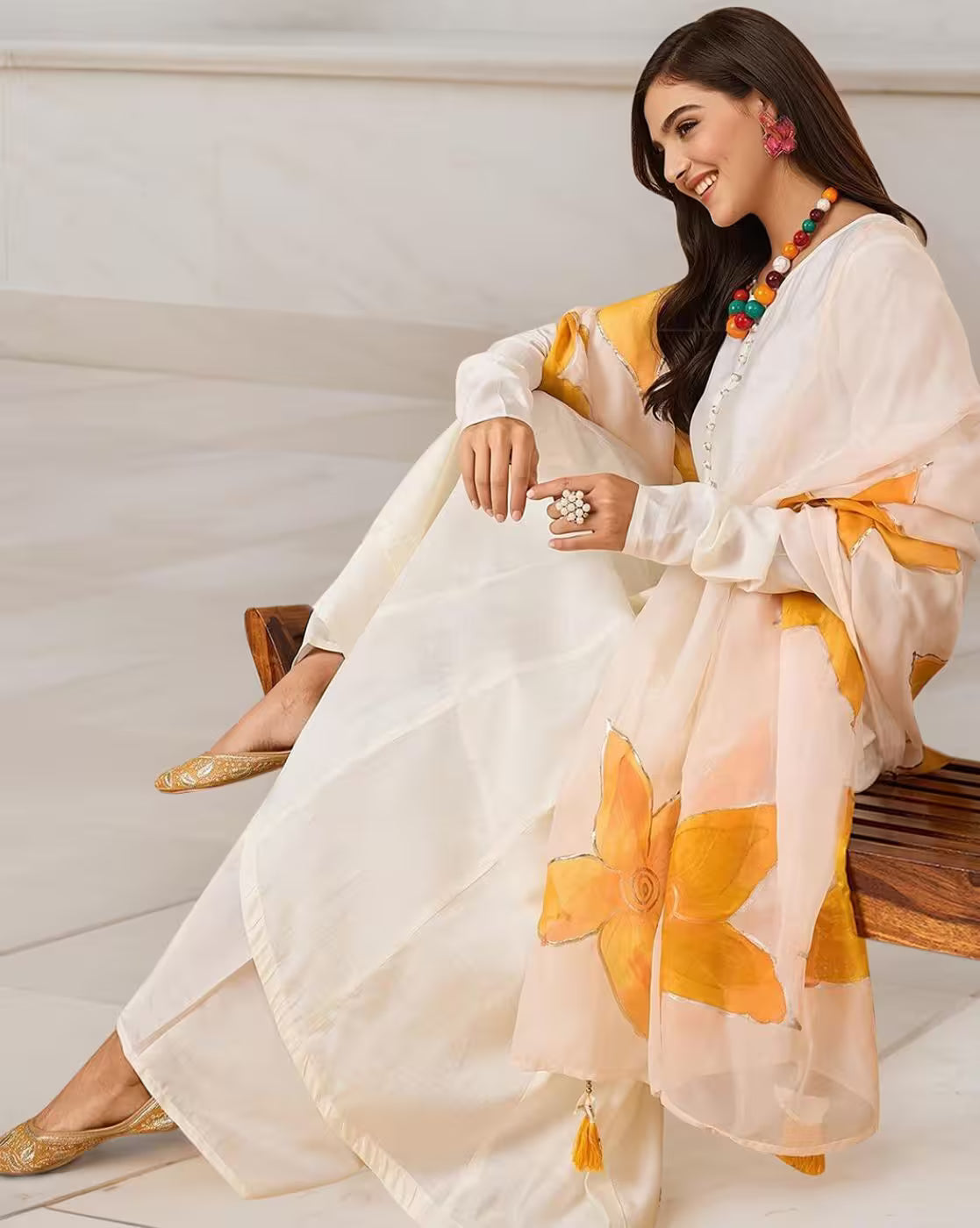 aromie three piece kurta set in ivory with yellow floral dupatta and gold juttis affordable silk blend kurta set