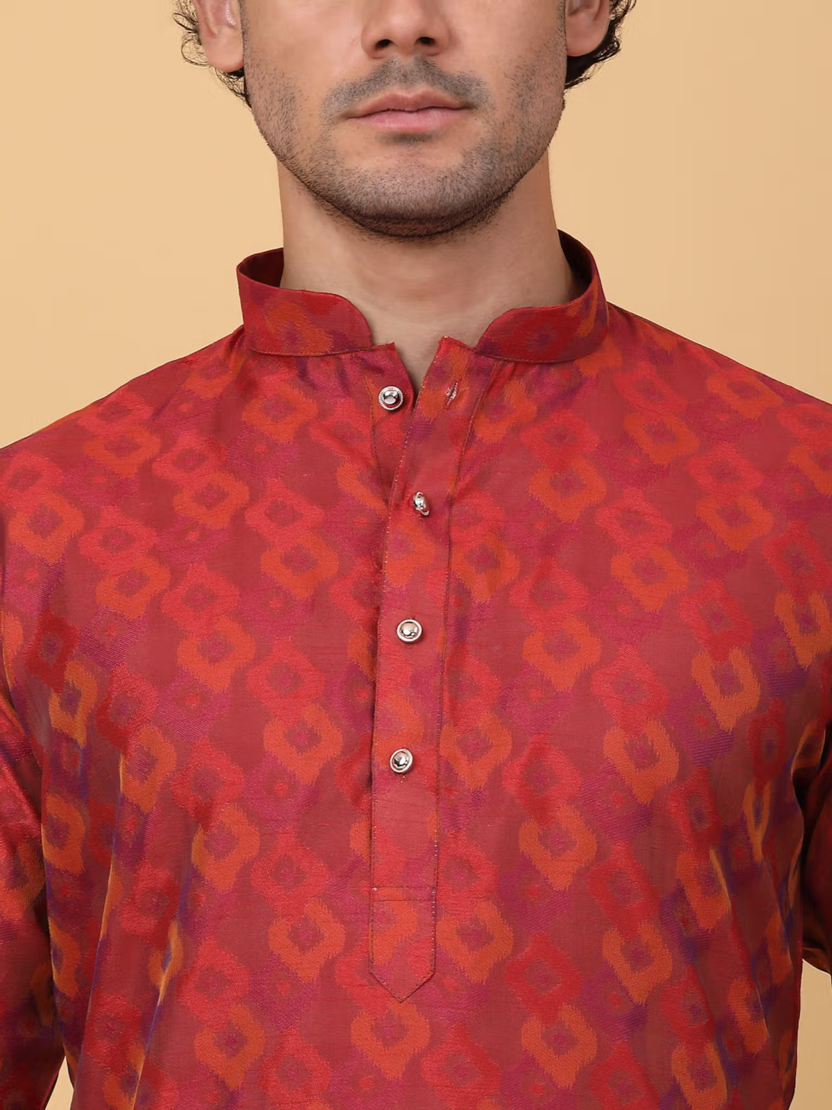 Model in men maroon silk kurta pajama set with band collar button placket and subtle geometric pattern