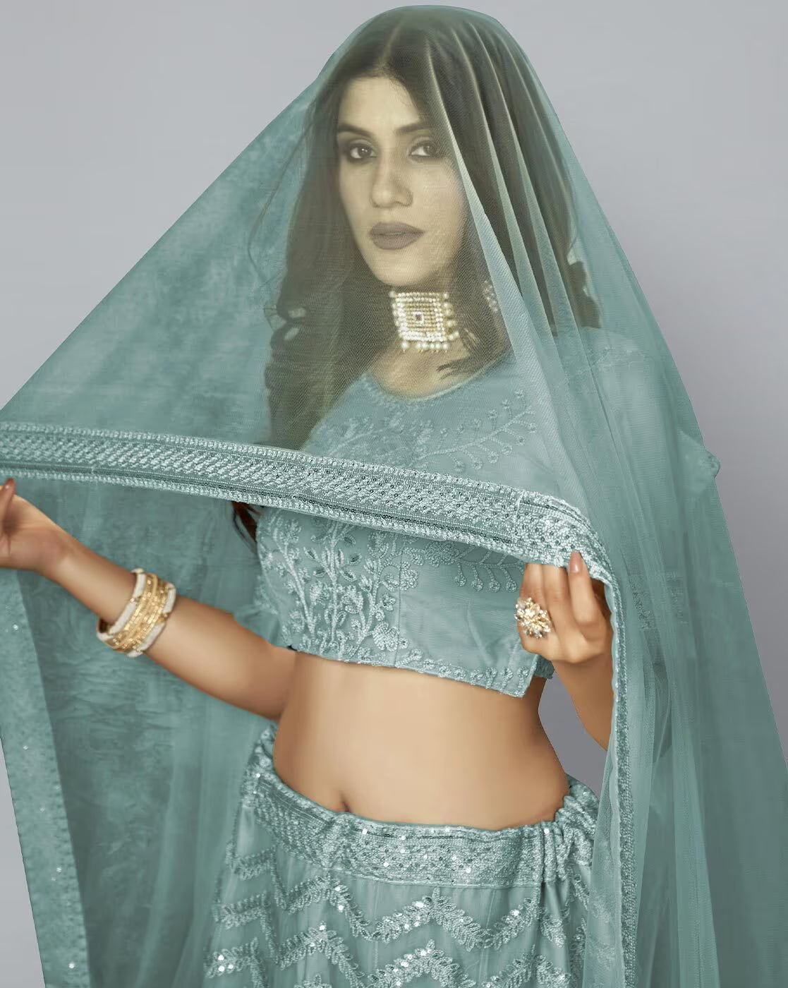 Model wearing Embellished A-Line Lehenga Choli Set in sea green with sheer dupatta and gold choker