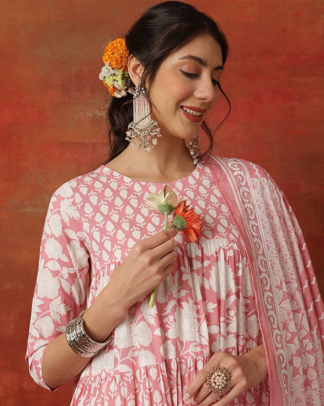 Pink white printed three piece kurtha with matching dupatta and jhumka earrings, model holds flower Cotton blend kurta set Canada