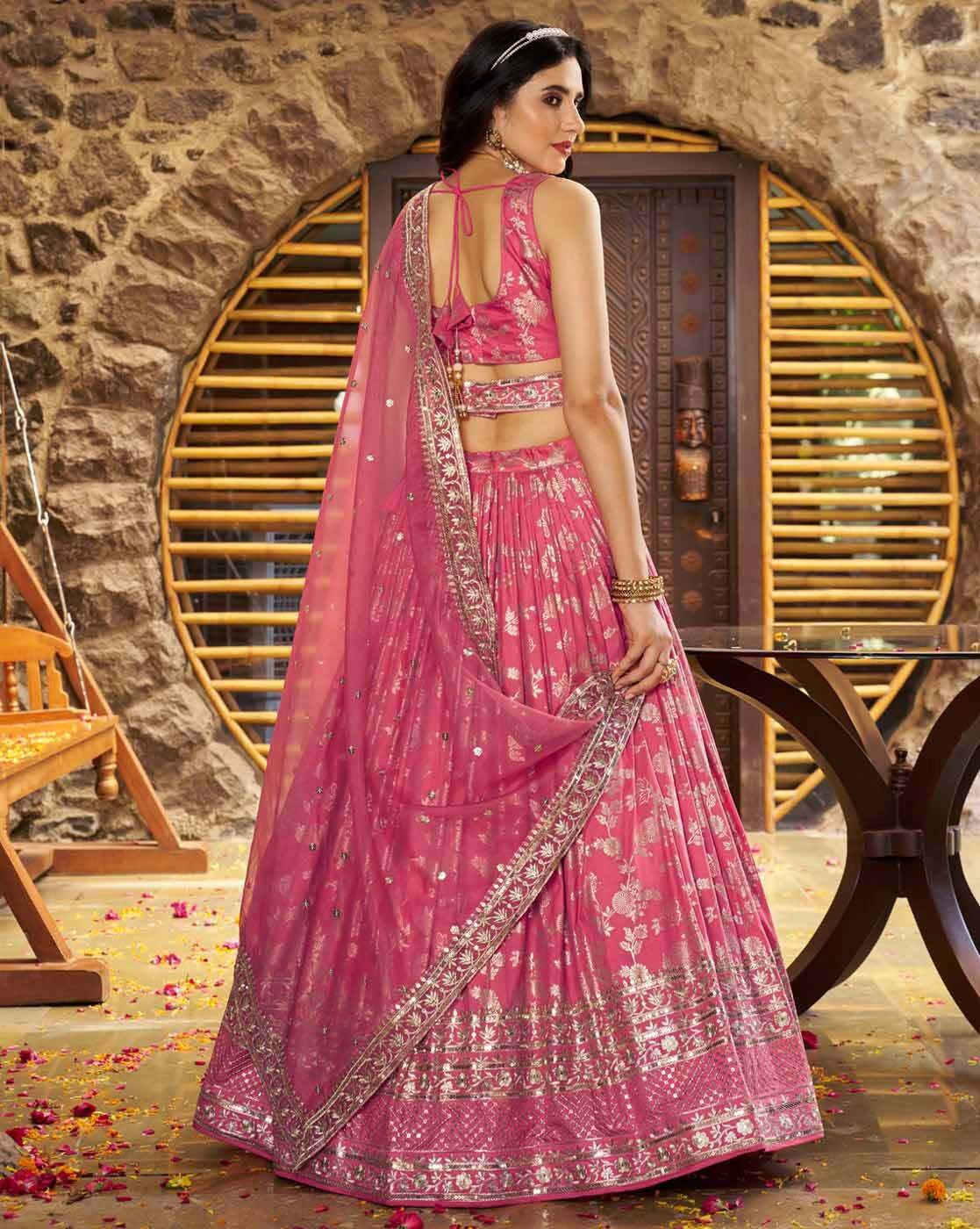Model in pink embroidered lehenga choli set Canada with open back blouse detailed silver embroidery and flowing dupatta